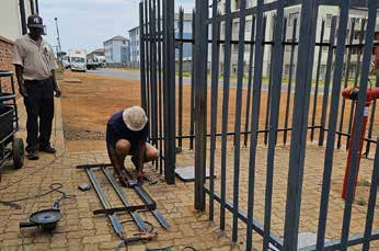Worker coating a corrugated metal roof